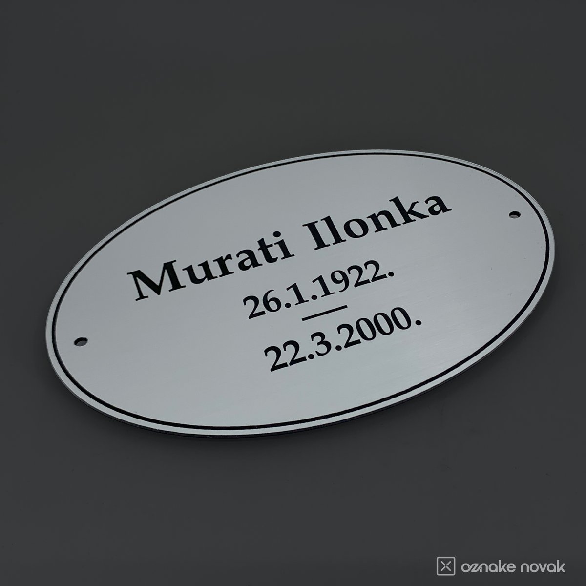 Smooth silver oval memorial plate with engraved name and dates