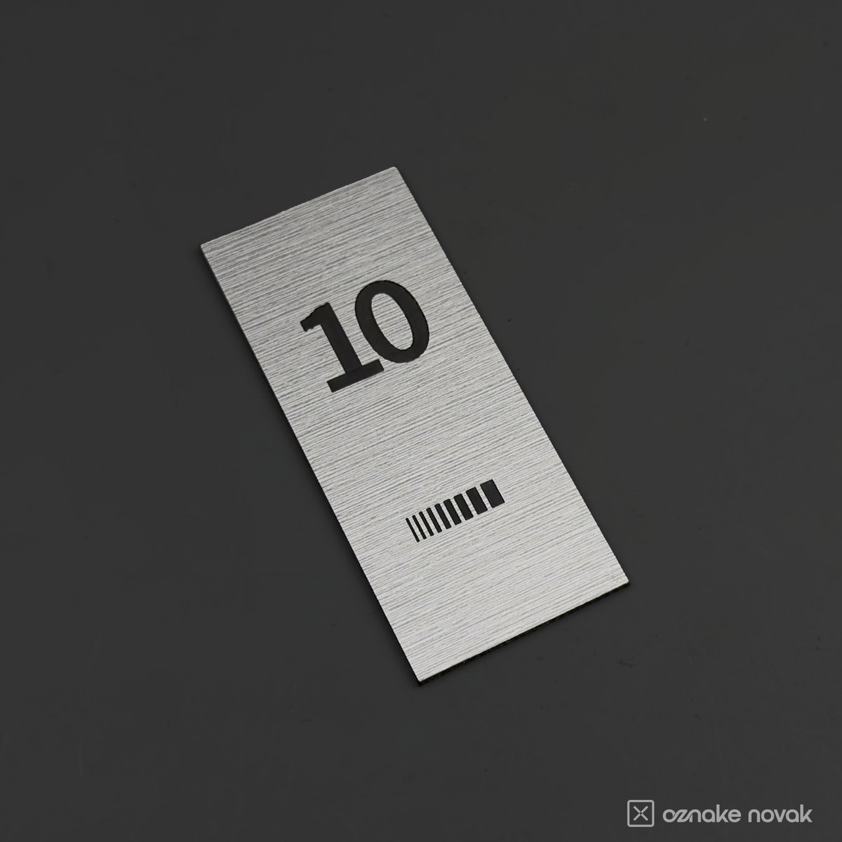 Brushed pewter office plate with engraved number 10 and Fina GS logo