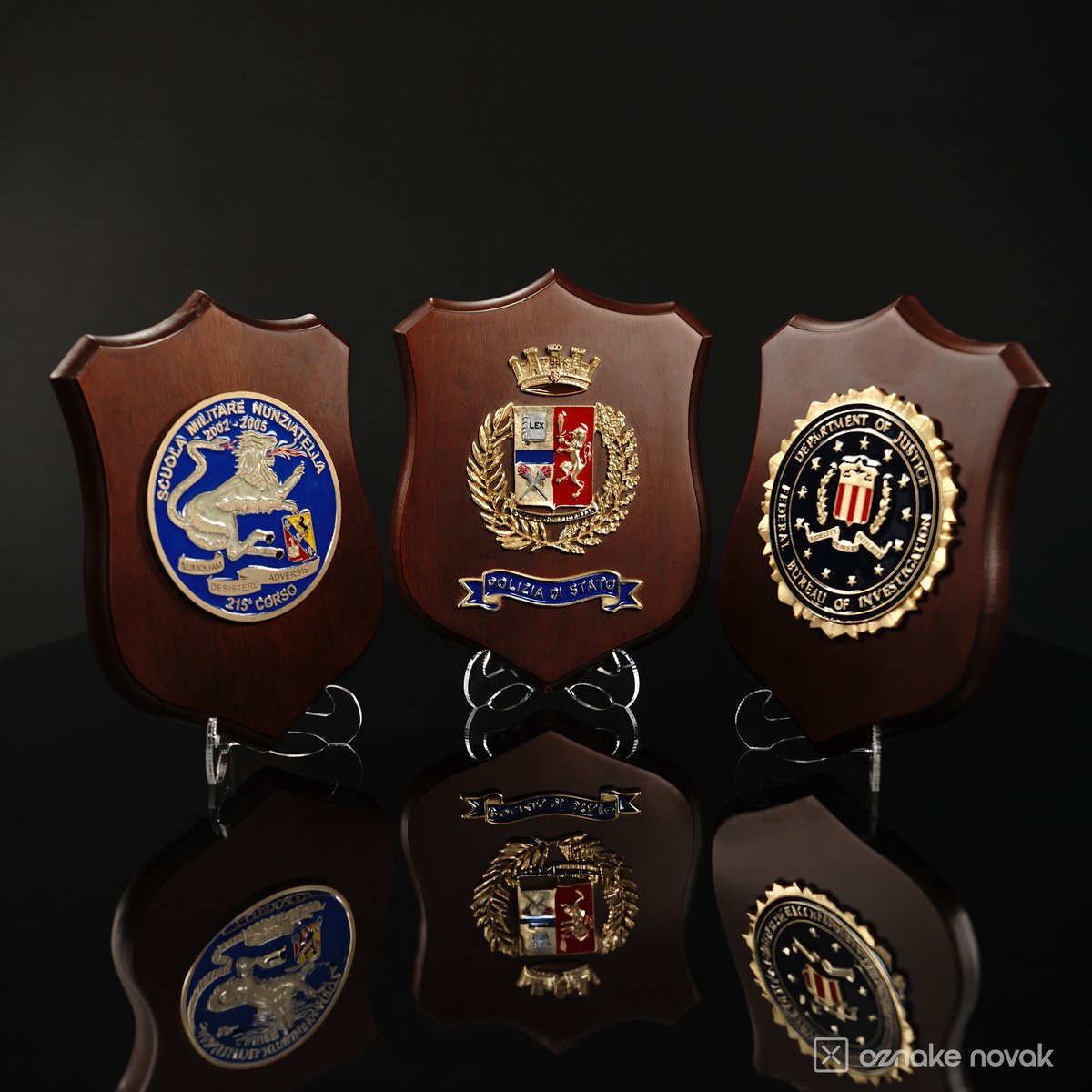 Three wooden shield plaques with different enamelled emblems, including a Polizia di Stato coat of arms