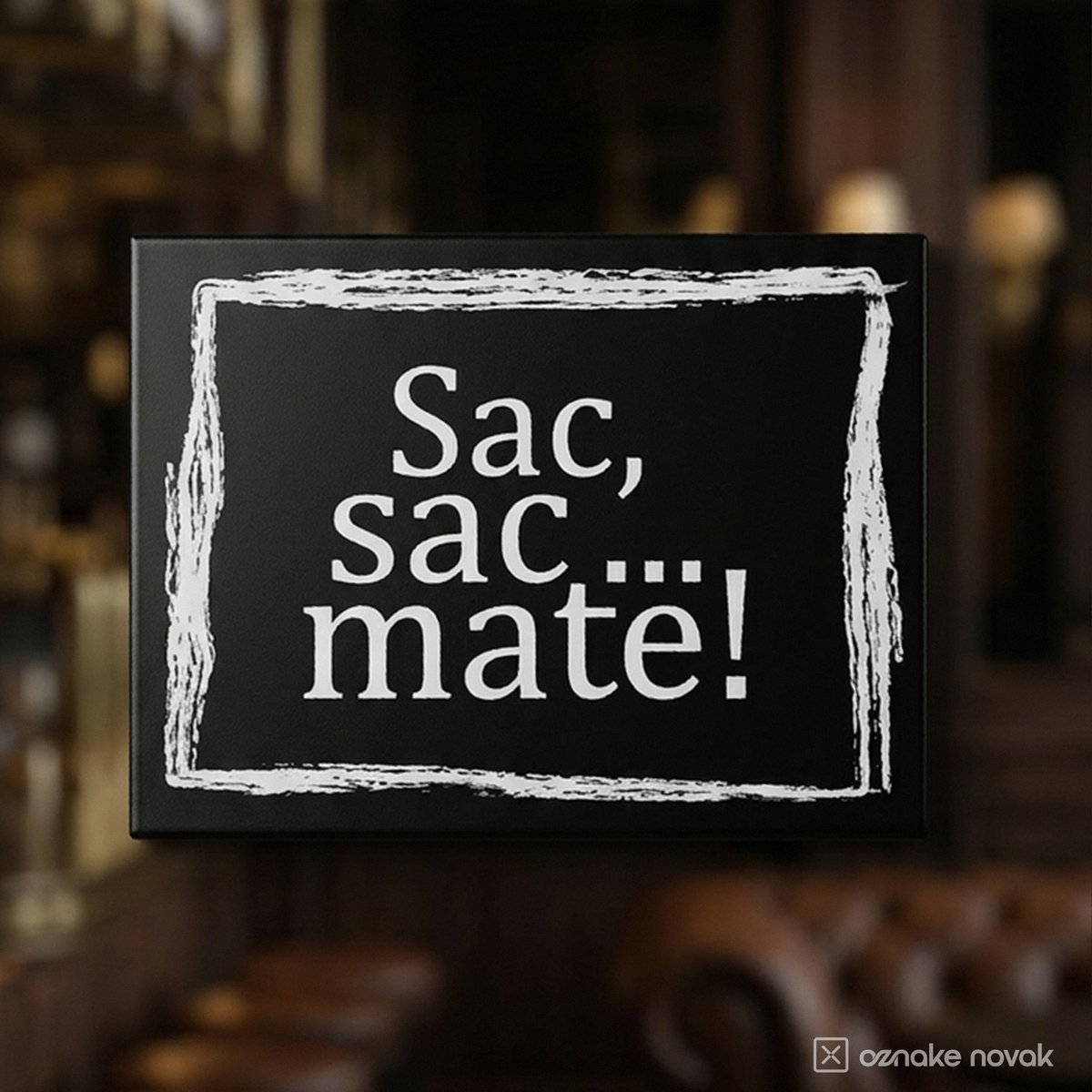 Black stainless steel name plate with white text Sac, sac... mate! in a chess club interior