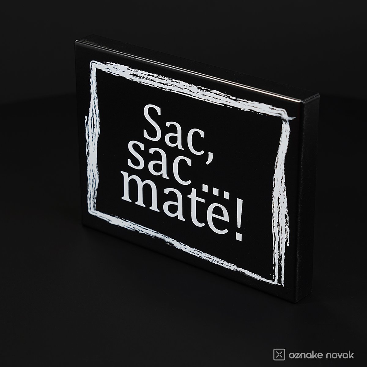 Angled view of the black Sac, sac... mate! plate showing the bent tray edge