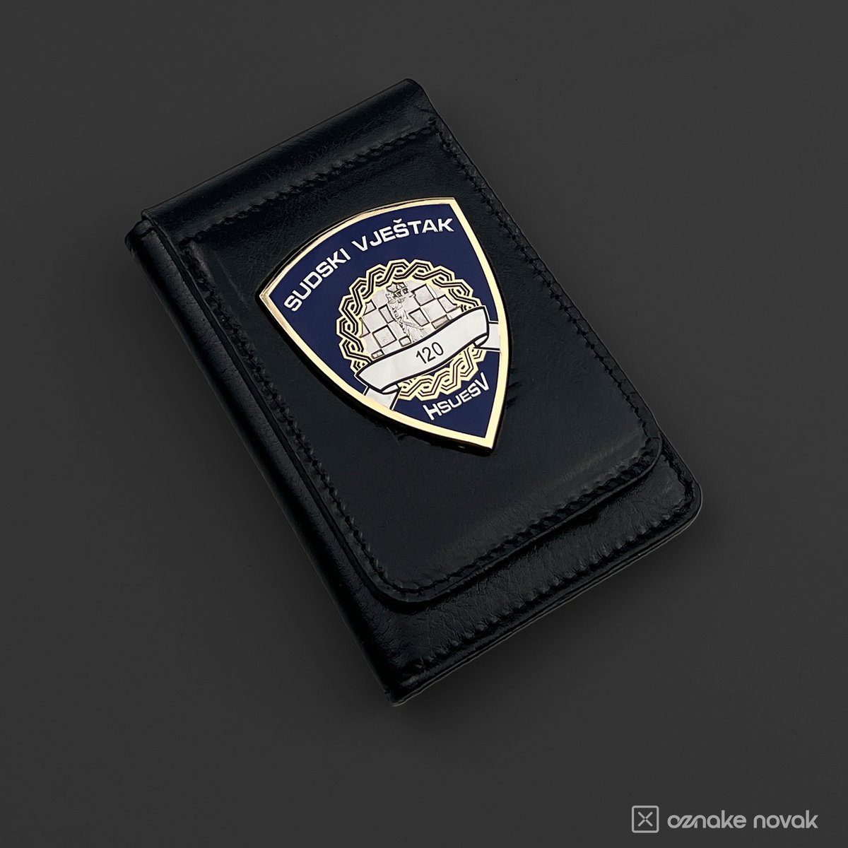 Black leather case with an enamelled Sudski vjestak HSUESV badge numbered 120