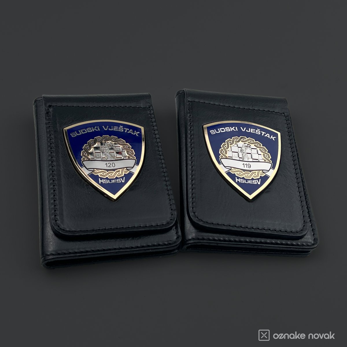 Two black leather cases with HSUESV badges numbered 120 and 119